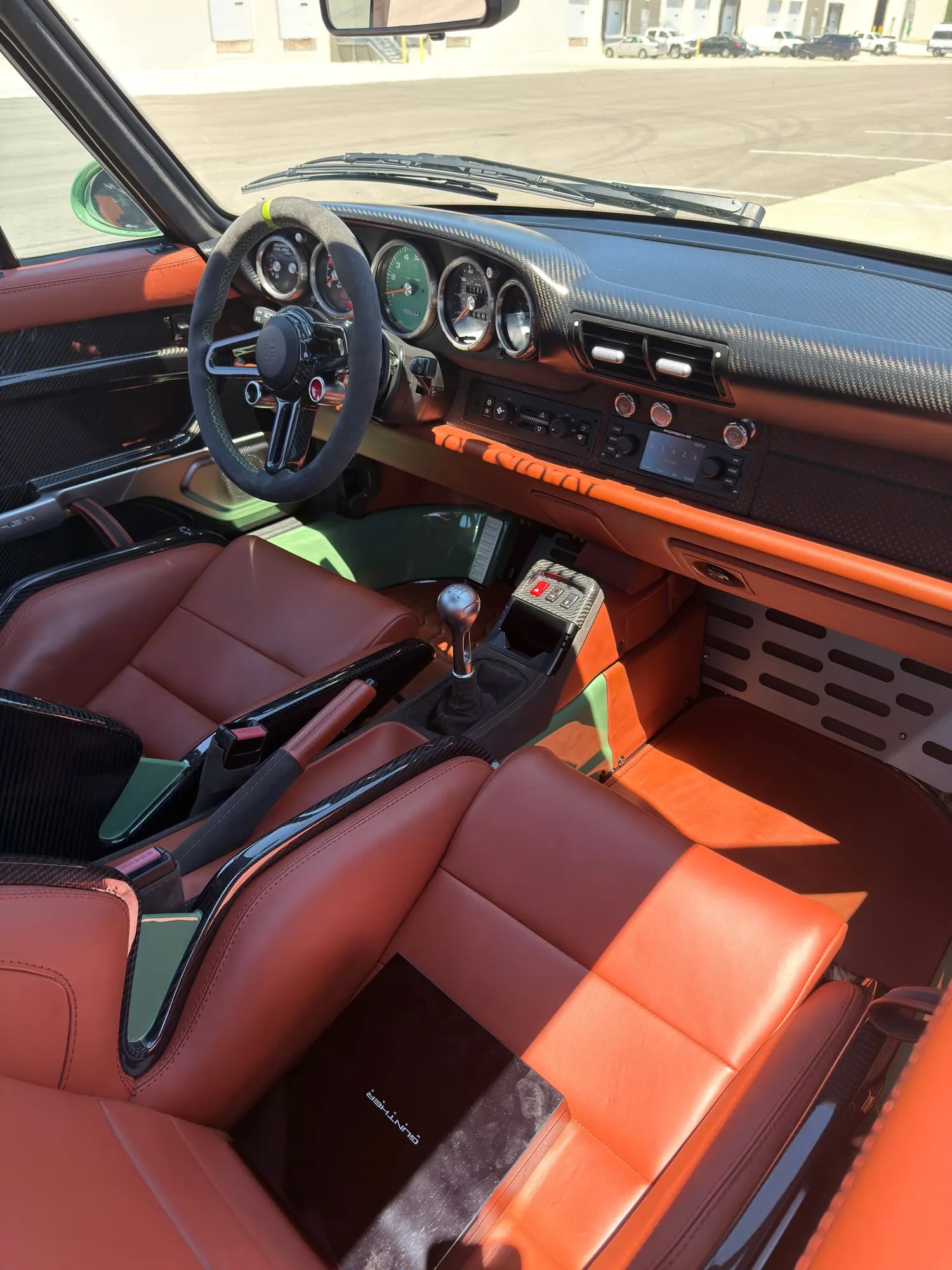 993 interior — carbon dash, terracotta leather, manual shifter